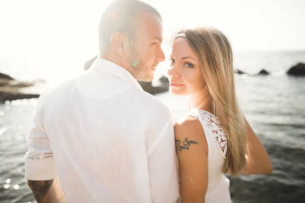 Fashion model couple with tattoo posing outside nea sea