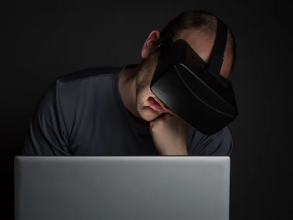 Tired addicted man to technology  using virtual reality headset