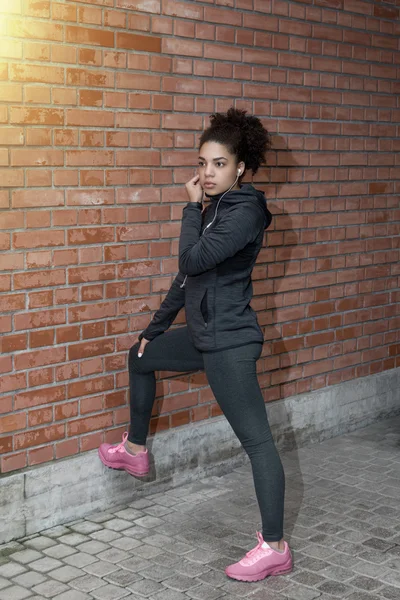 Portrait of young woman wearing sportswear on city street