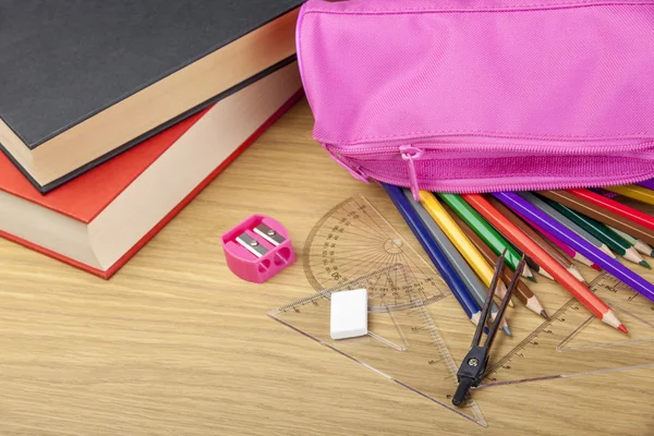 Coloring pencils spilling out of a pink pencil case