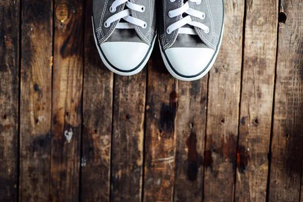 Ukraine, Kiev, October 30, 2016: crey Converse shoes on wooden