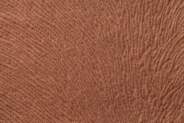 Light brown background from soft textile material. Fabric with natural texture.