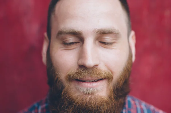Bearded young man dreams closing his eyes