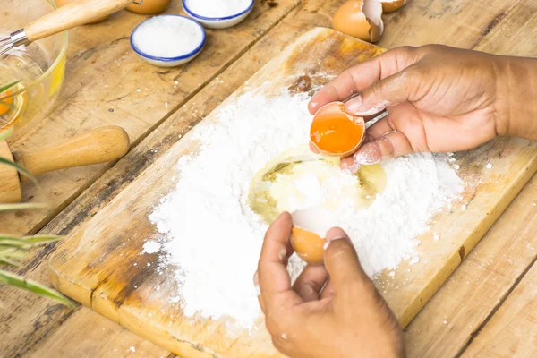 Man baking bread and egg in his hand.Close up.