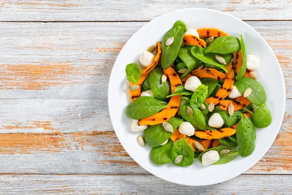 Grilled pumpkin, mini mozzarella, baby spinach and pumpkin seeds