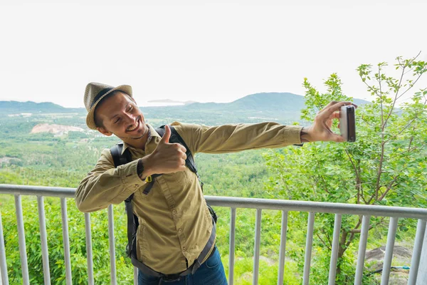 tourist with backpack on view point  make selfie