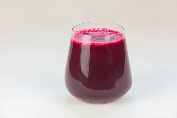 Beet juice in glass on  table