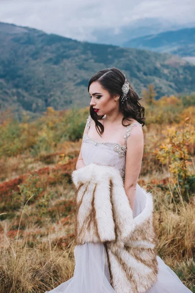 Beautiful bride posing in mountains