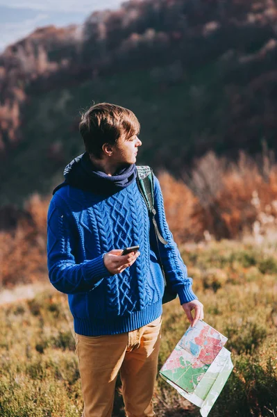 Tourist in mountains with map