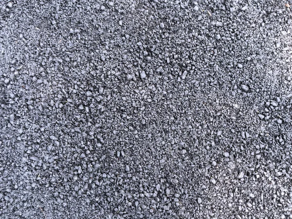Rocky surface textured background. Gray and black pebbles pattern.