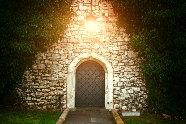 Old Lantern fabulous door from the top. Lantern shines at the door.