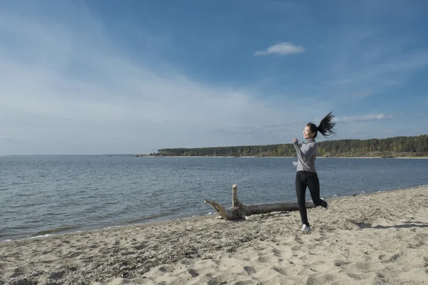 Asian girl running beside the sea