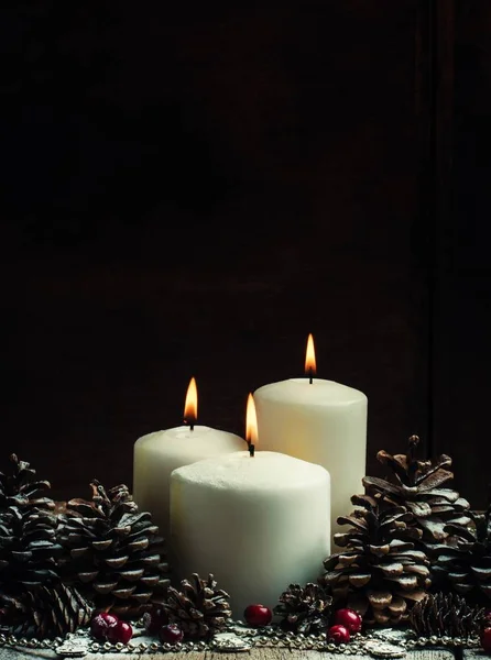 Christmas or New Year\'s composition with burning white candles