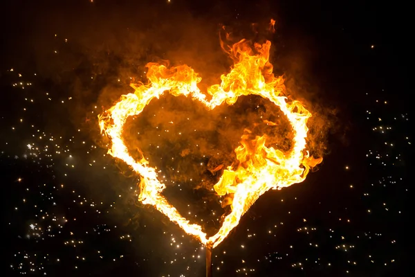 Fiery heart. Fire in the night. Heart on fire. Sparks from the f