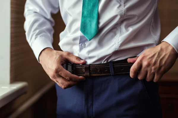 Man putting on a belt, Businessman, Politician, man\'s style, male hands closeup, American businessman, European businessman, a businessman from Asia, People, business, fashion and clothing concept