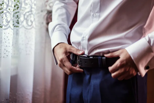 Man putting on a belt, Businessman, Politician, man\'s style, male hands closeup, American businessman, European businessman, a businessman from Asia, People, business, fashion and clothing concept