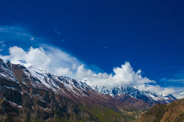 Landscape Snow Mountains Nature Viewpoint.Mountain Trekking Landscapes Background. Nobody photo.Asia Travel Horizontal picture. Sunlights White Clouds Blue Sky. Himalayas Rocks View.