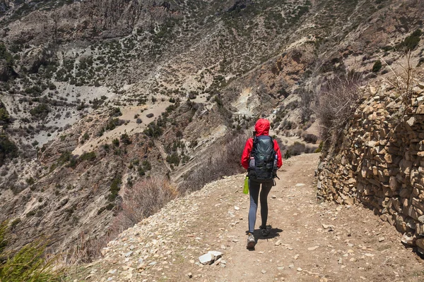 Young Pretty Woman Wearing Red Jacket Backpack Trail Mountains.Mountain Trekking Rocks Path Landscape View Background. Horizontal Photo.