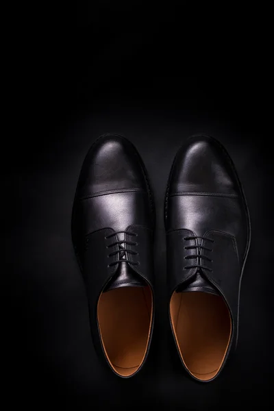Black oxford shoes on  background. Top view. Copy space.