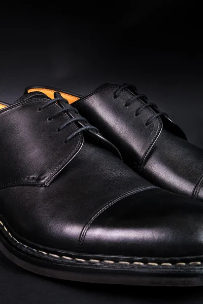 Black oxford shoes on  background. Back view. Close up.