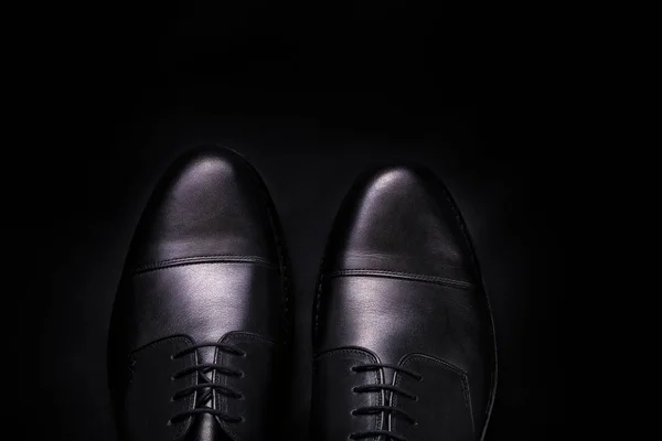 Black oxford shoes on  background. Top view. Copy space.