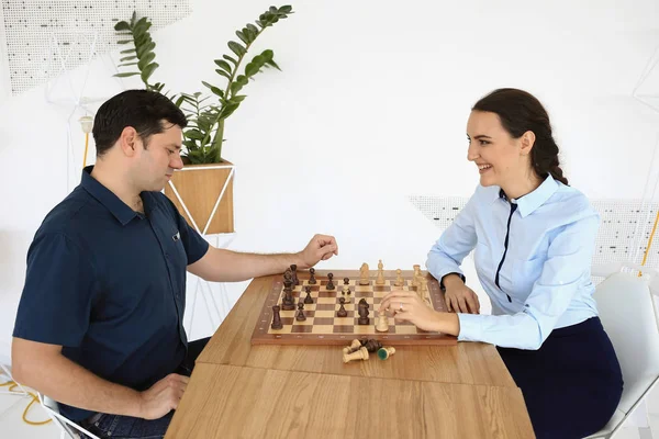 Man and woman are playing the chess