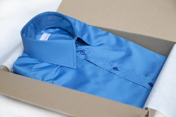 Blue shirt packed in paper box