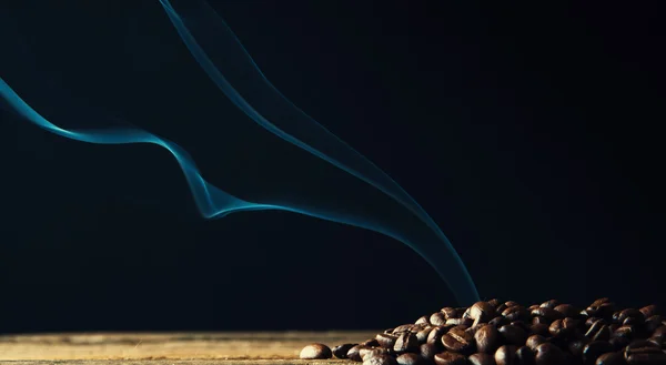 Smoke rising over roasted coffee beans
