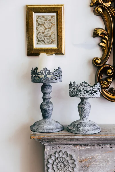 Vintage candle holders on fireplace