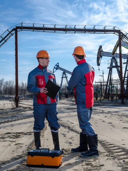 Two workers in the oilfield