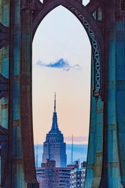 A surreal take on a common view of the Empire State Building from under the Manhattan Bridge.