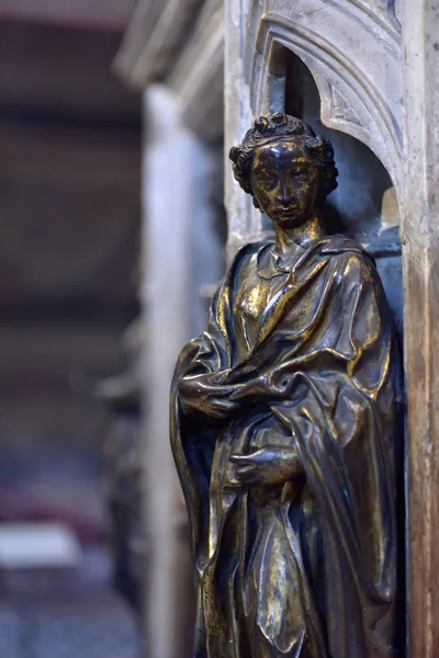 Woman bronze statue in a catholic church, Siena, Italy
