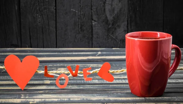 Word love made of paper and red Cup