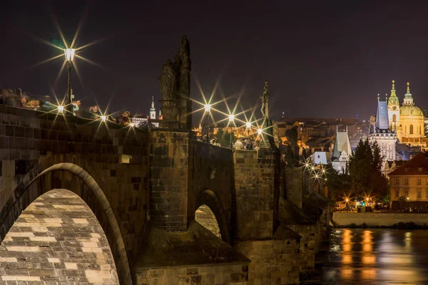 Prague, Czech Republic, September 28, 2016: Charles Bridge, night view, one of the most popular destinations among tourists.