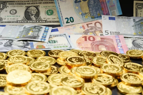 Euro bills and dollar bills and gold coins