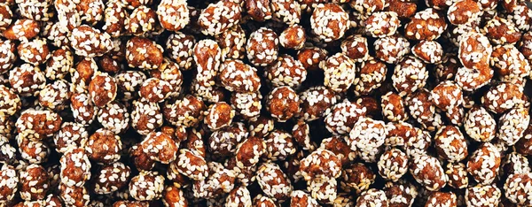 Peanuts in caramel with sesame seeds, panorama