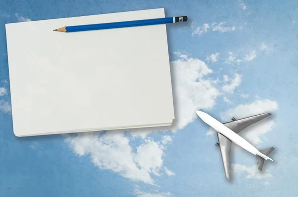 Blank notebook page with plan sky travel background