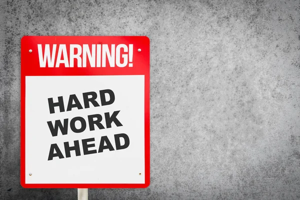 Red Hard work ahead warning sign with copy space. Business concept on Hard work for successful in career. Making a motivative decision on the future by commuting to Hard work.