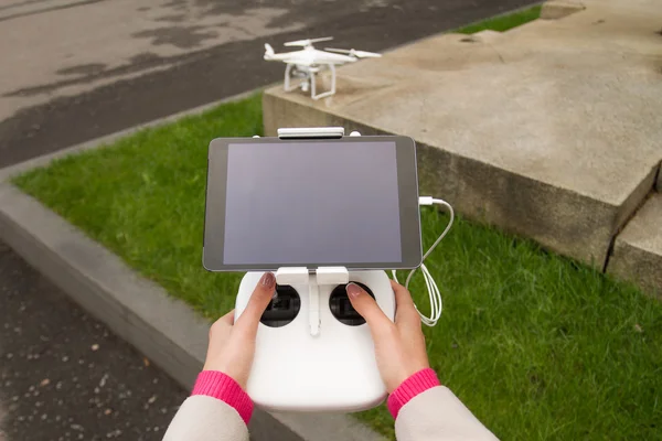 Demonstration of unmanned copter. Remote control in a woman\'s hands.