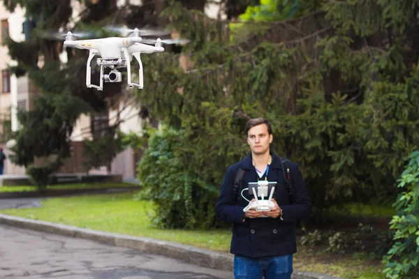 Young man with flying drone. New technology