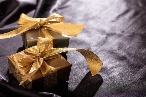 Gift boxes on a black satin background