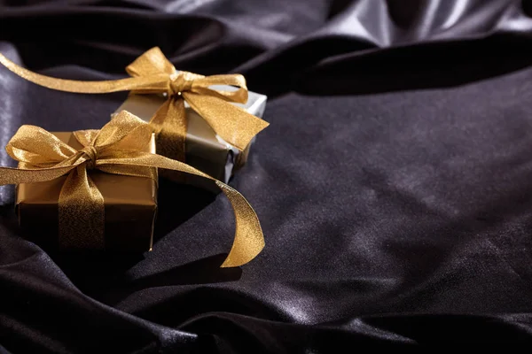 Gift boxes on a black satin background