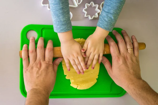 Children and dad hands rolled shortcrust dough