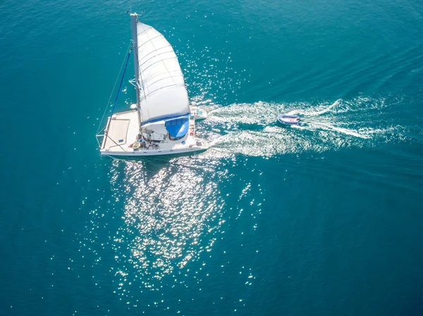 Aerial view of sailing boats walking on the sea