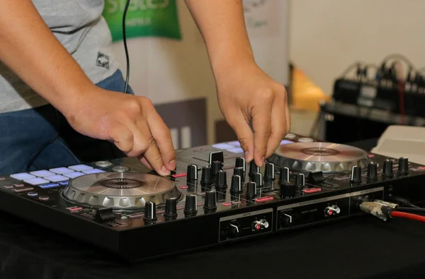 Dj mixes and playing the track controller turntable. New digital DJ technology for mixing audio tracks from notebook or flash drive.