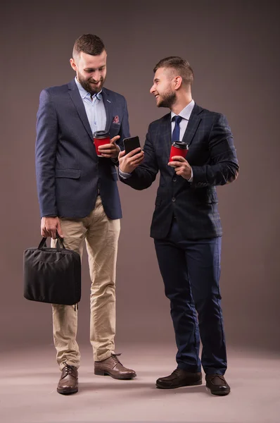 Two men drinking coffee and talking