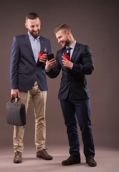 Two men drinking coffee and talking