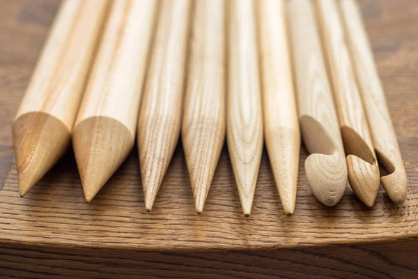 Wooden knitting needles on wooden table