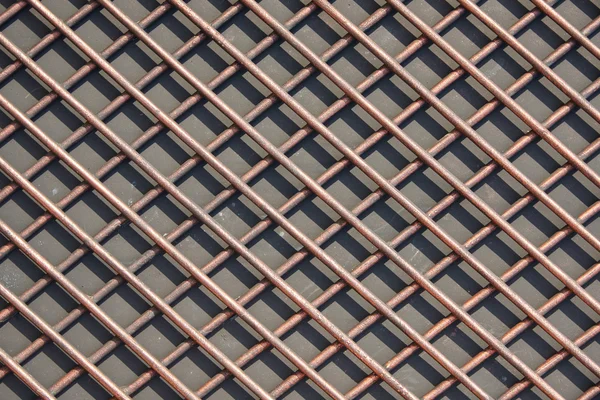 The grid of thick rods. Rods made of nonferrous metal. Texture,