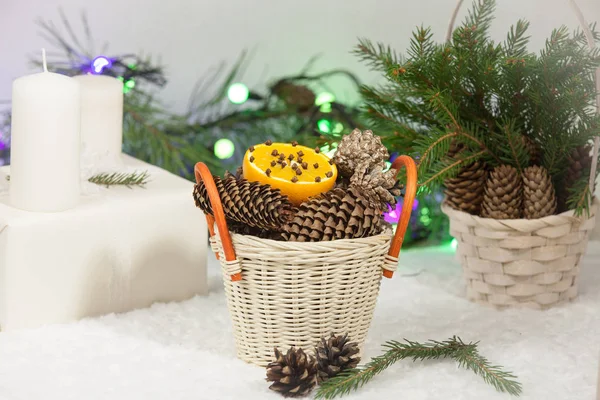 Christmas background: sweets, orange, pine cones and fir branches.